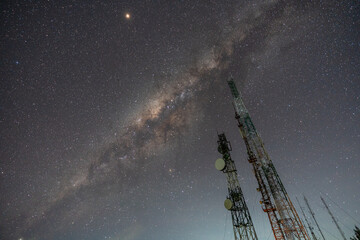 Telecommunication poles with Star and Milky way in the back.