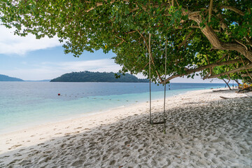 scenic view of beautiful Sai Khao (white sand) Beach with swing in Ra Wi Island, Southern of Thailand