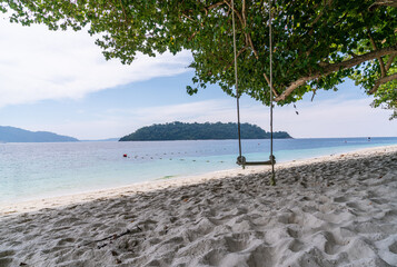 scenic view of beautiful Sai Khao (white sand) Beach with swing in Ra Wi Island, Southern of Thailand