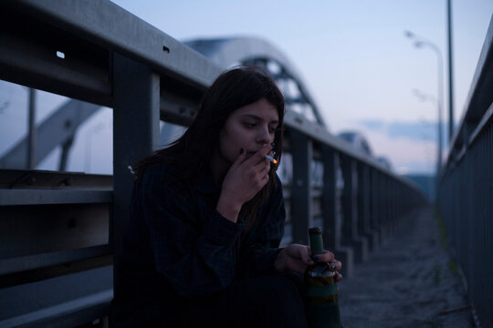 cinematic photo of a girl on a night bridge
