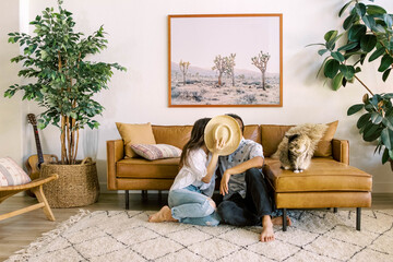 Young couple kissing in living room