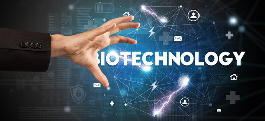 Hand pointing at BIOTECHNOLOGY inscription, modern technology concept