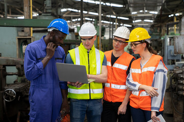 Industrial engineers have to consult with colleagues while using laptop. Supervisor, worker with hard hat working in manufacturing factory on business day. Concept of workplace gender equality - obrazy, fototapety, plakaty
