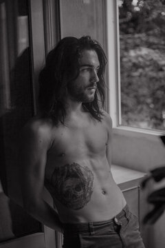 Black and white portrait of a guy on the balcony