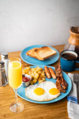 american breakfast with mimosa on wooden table top