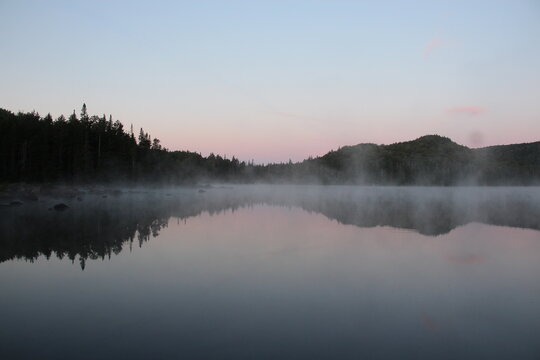 Mist rising from the warm lake at dawn