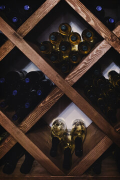 A collection of wine bottles in dark basement