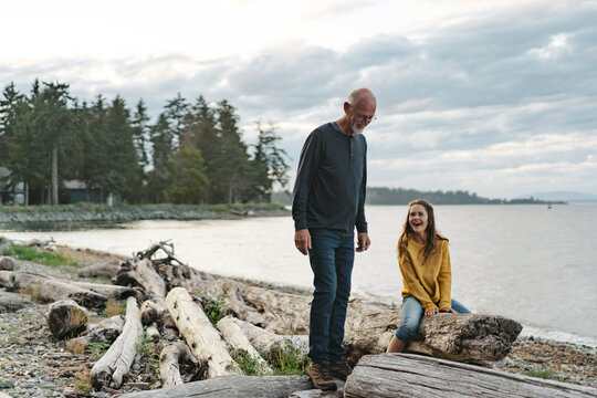 Grandfather playing with grandkid outside.