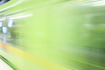 High speed green metro in subway station. Motion blur effect of subway train. Transportation...