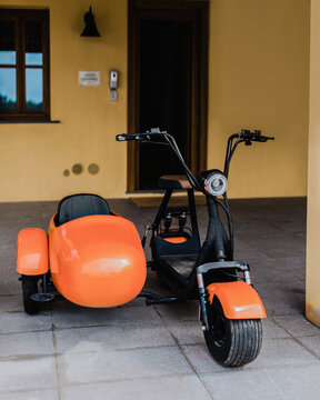 Sidecar parked in front of open house entrance door