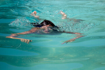 person swimming in the pool