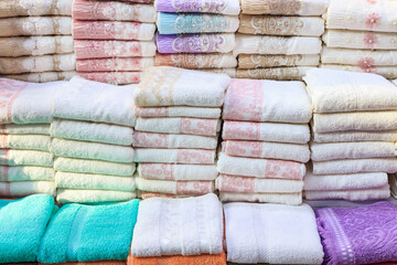 Stack of towels on shop stand. Pile of colorful hand towels. Famous Bursa towels in Turkey.