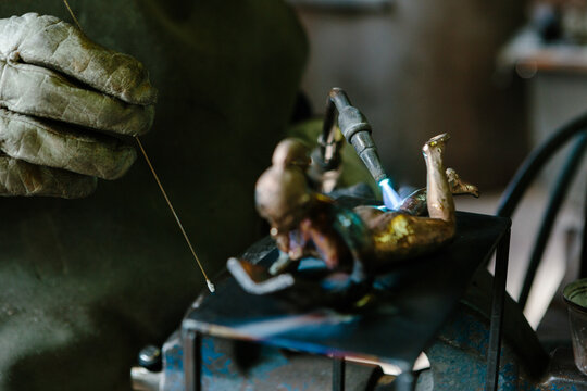 Hand using a blowtorch in a foundry