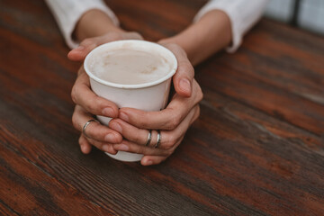 Woman holding a cup of latte