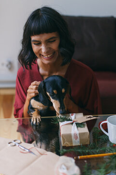 Woman wrapping Christmas gifts indoor