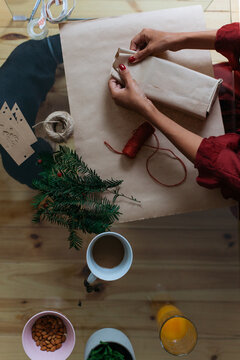 Woman wrapping Christmas gifts indoor