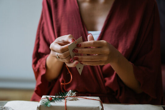Woman wrapping Christmas gifts indoor