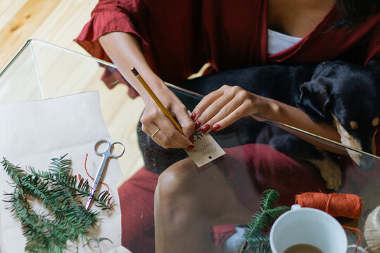 Brunette woman writing a Christmas card
