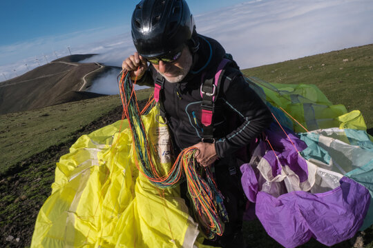 Man carrying paraglider