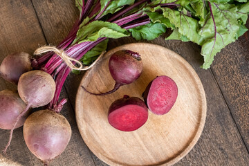 Cut up red beets with leaves on a table