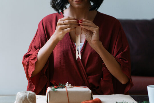 Woman wrapping Christmas gifts indoor