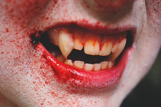 Close up of vampire's mouth and teeth splattered with blood