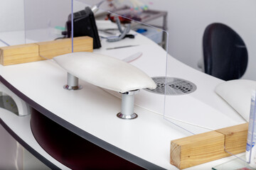 Workplace of the manicure master. Dividing separation plastic shield partition for the safety distance during coronavirus pandemic