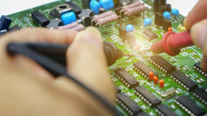 Electronics repair with tester.Repair technician test On an electronic board.Selective focus.	