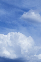 Blue sky with dramatic cumulus clouds.
