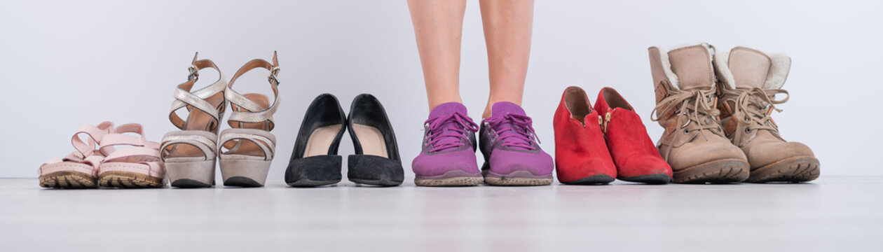 The woman chooses comfortable shoes. Widescreen photo.