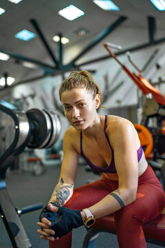 girl resting in the gym between sets
