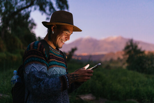 Handsome man using phone in nature