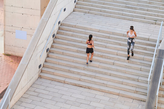 Women training together on city stairs