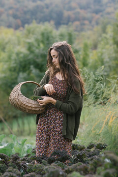 Gardener With Basket Walking Through Field