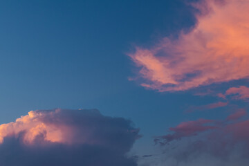 Colorful clouds at sunset in blue sky.