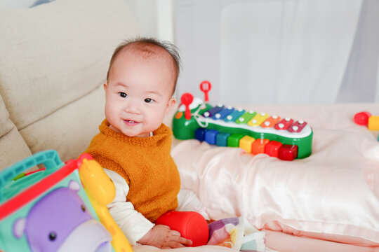 portrait of cute baby girl lying on bed at home