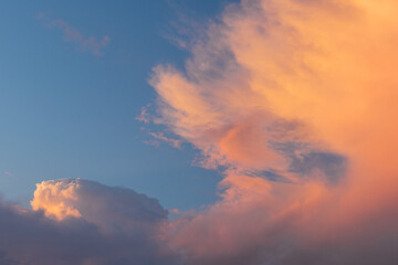 Colorful clouds at sunset in blue sky.