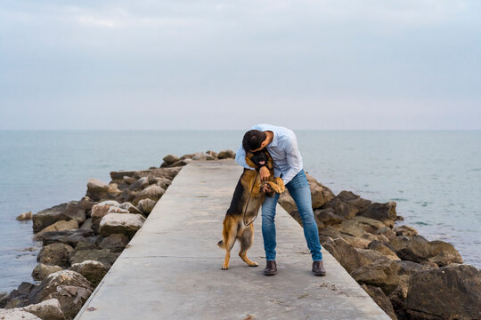 Man walking outdoor with his cute german shepherd dog