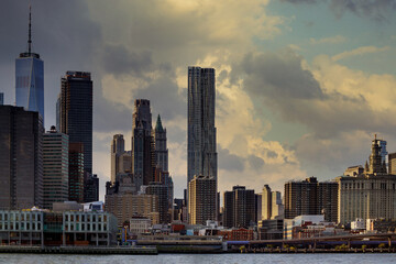Fototapeta premium New York City Harbor on a barge sails up the east river against the lower Manhattan skyline standing tall