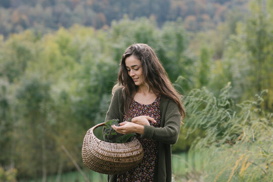 Gardener With Basket Walking Through Field