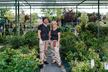 Happy mid adult couple working in nursery