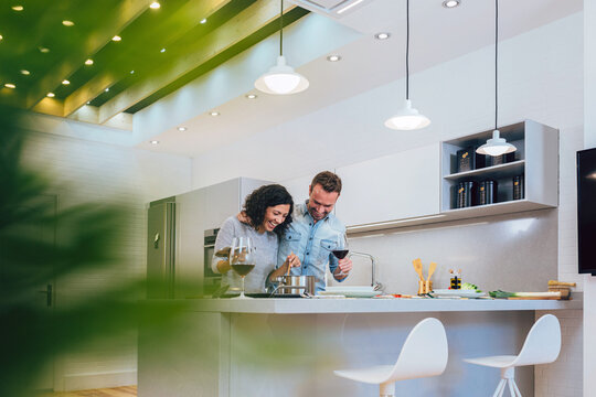 Couple preparing pasta in kitchen