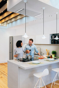 Couple preparing pasta in kitchen