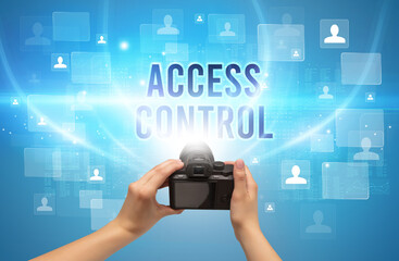 Close-up of hand holding camera with ACCESS CONTROL inscription, video surveillance concept