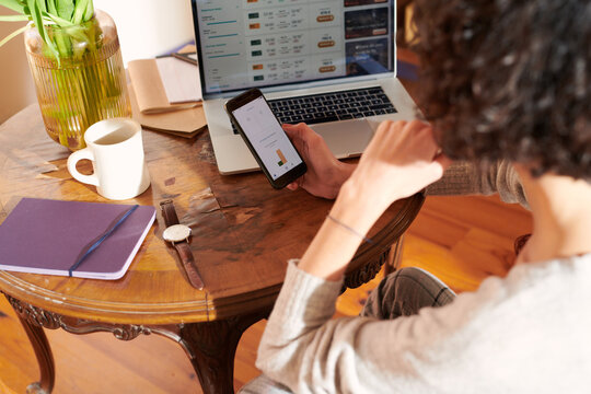 Business woman looking at statistics on smartphone screen