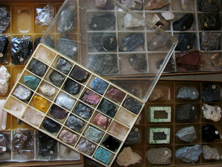 A collection of rock and mineral samples for working in Geology is in plastic boxes