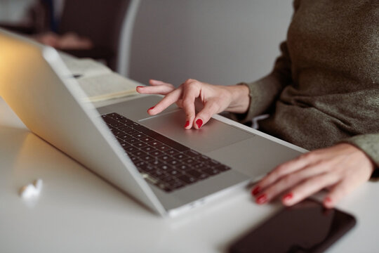Woman using touchpad on her laptop.