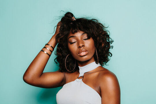 Portrait of sexy black woman over light blue background
