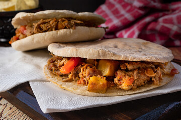 Barbeque Pulled Pork Sandwich with BBQ Sauce on pita bread and Fries. Rustic enviroment