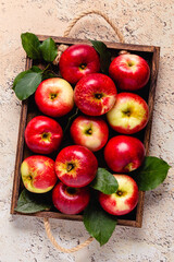 Ripe red apples in wooden box.